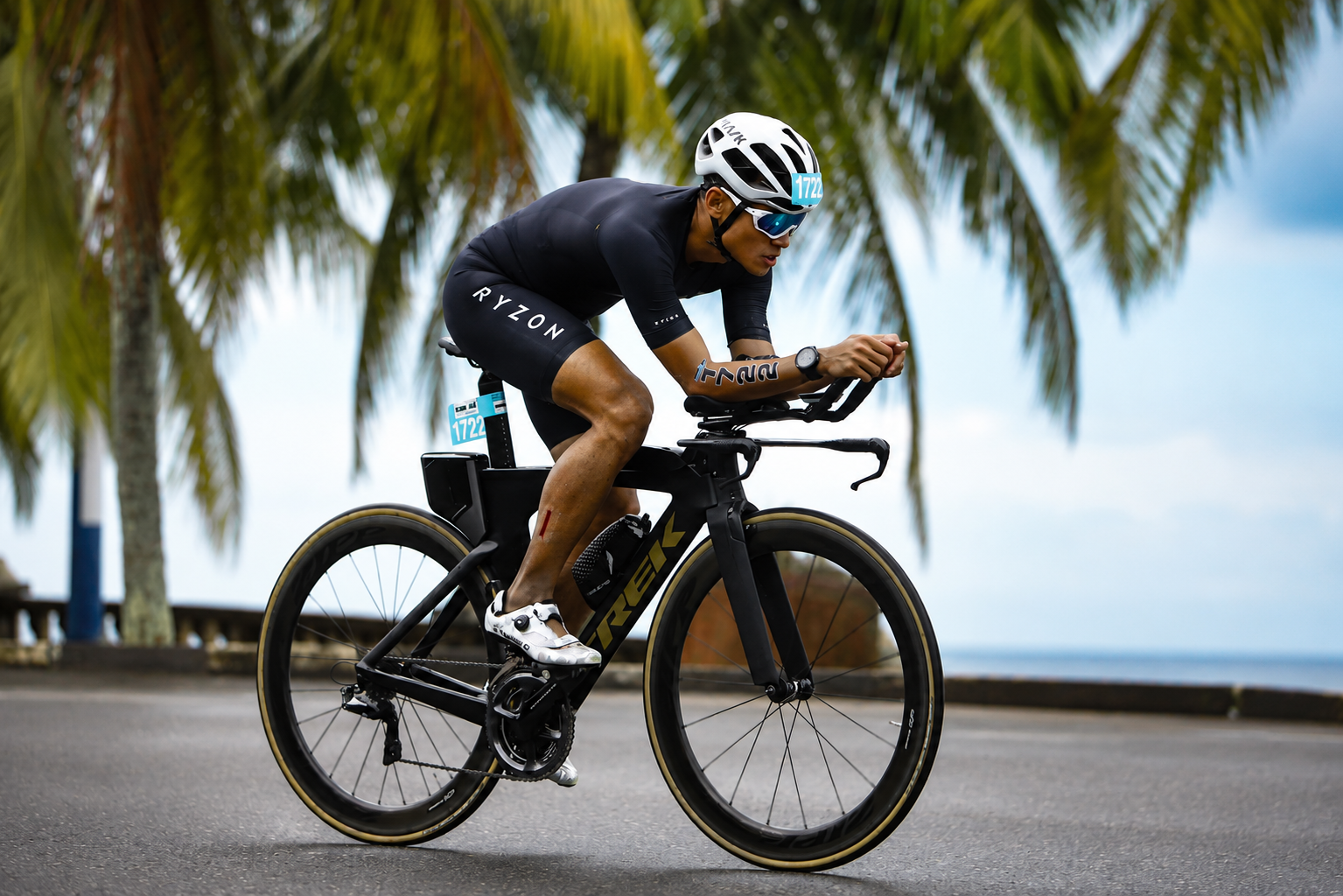 Dr. Nik Qisti Fathi competing in a triathlon — the same discipline and preparation that translate to the operating theatre